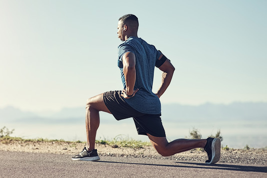 Adult Over 40 Performing Standing Hip Exercise