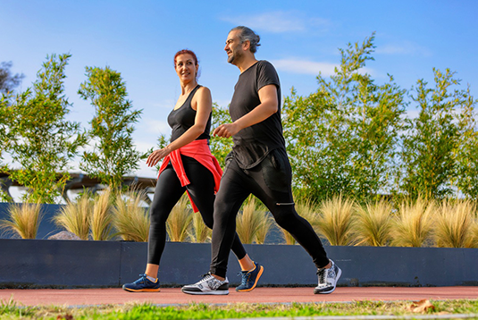 Adult walking on a level park path,