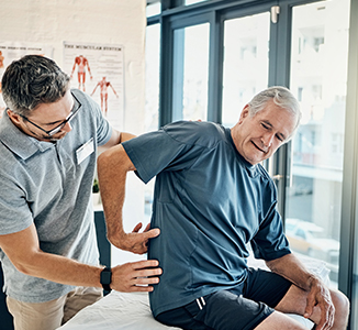 Physician evaluating a patient with back pain